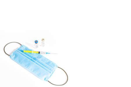 Syringe with vaccine and ampule and medical face maskの写真素材