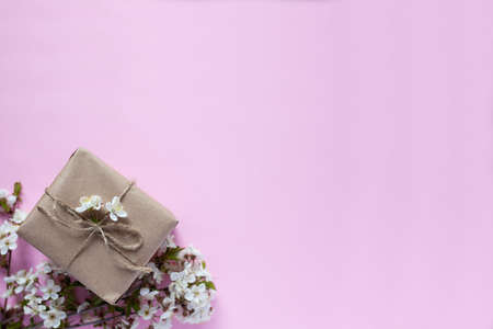 Handmade gift box with cherry flowers on background isolated on colorの写真素材