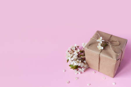 Handmade gift box with cherry flowers on background isolated on colorの写真素材