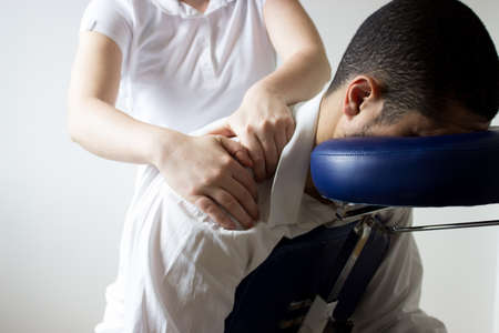 businessman receiving shiatsu on a quick massage chairの写真素材