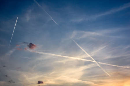 Multiple contrails (Condensation trails) at sunset.