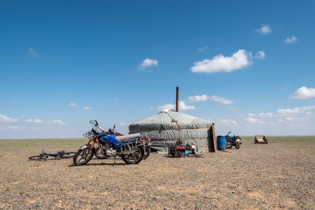 Mongolian yurt and motorbike in the steppe