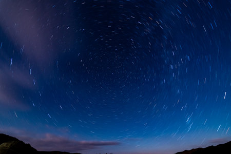 Star trails in the night sky. Long exposure photograph with grain.の写真素材