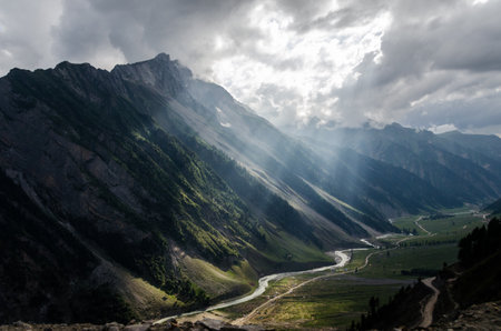Panoramic view of the mountains and the river in the cloudsの写真素材