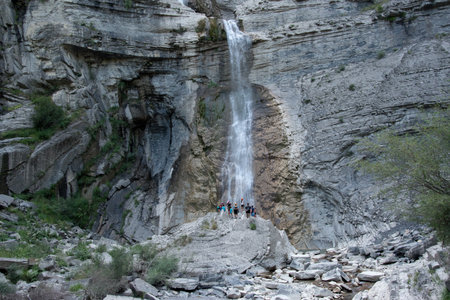 Waterfall in the mountains of the Crimean peninsula. People climb the rocks.の写真素材