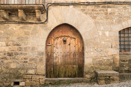 Old wooden door in the medieval village of Ainsa, Aragon, Spain