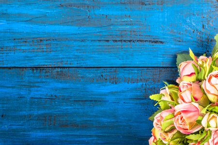 Valentine roses flowers on blue wood background useful as valentine card.の写真素材