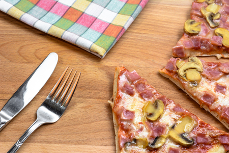 Pieces of pizza on wooden board, selective focus.の写真素材