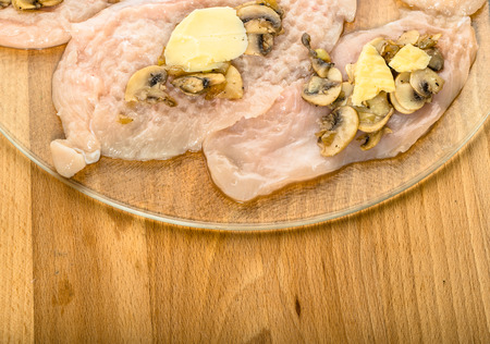 Preparation of chicken kiev from chicken breast stuffed with cheese and mushrooms.の写真素材