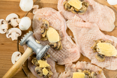 Preparation of chicken kiev from chicken breast stuffed with cheese and mushrooms.の写真素材