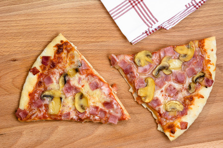 Pieces of pizza on wooden board.の写真素材
