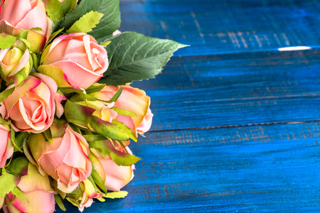 Valentine roses flowers on blue wood background useful as valentine card.の写真素材