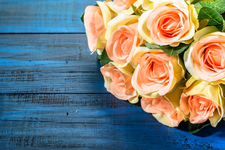 Valentine roses flowers on blue wood background useful as valentine card.の写真素材