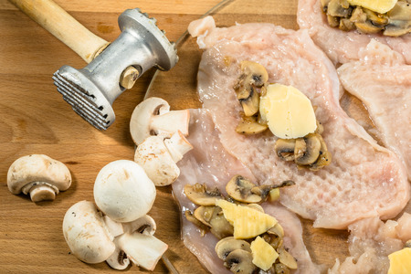 Preparation of chicken kiev from chicken breast stuffed with cheese and mushrooms.の写真素材