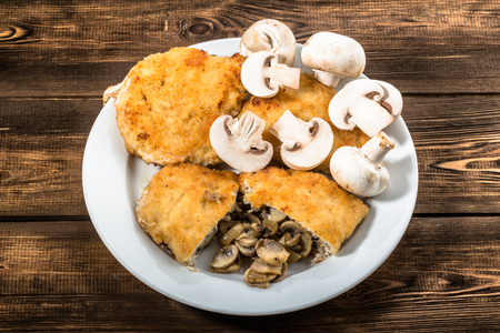 Fried chicken kiev from chicken breast stuffed with champignons.の写真素材