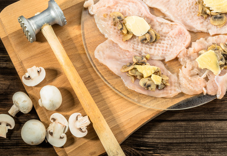 Preparation of chicken kiev from chicken breast stuffed with cheese and mushrooms.の写真素材