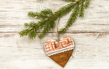 Hanging decoration shaped heart on christmas tree.の写真素材