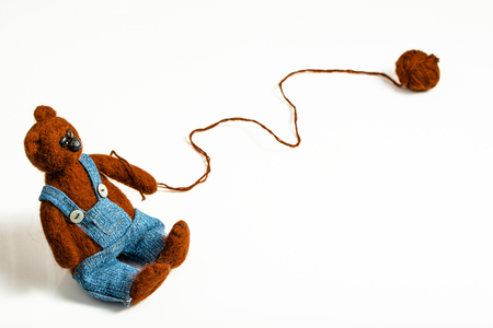 Felt teddy bear dressed in pants isolated on white background.の写真素材