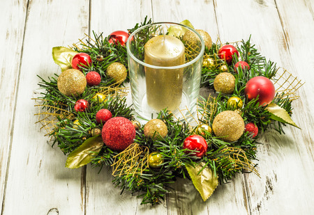 Christmas wreath with candle on wooden tableの写真素材