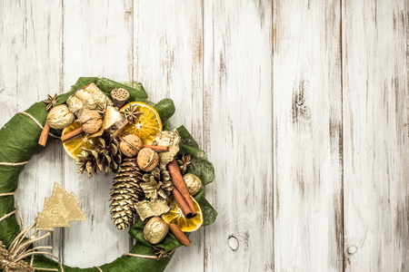 Christmas wreath with dried fruits on wooden doorの写真素材