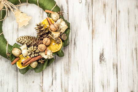 Christmas wreath with dried fruits on wooden tableの写真素材