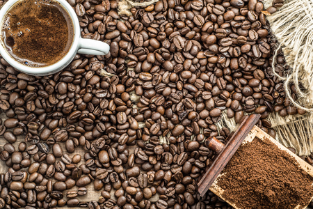 Cup of coffee and coffee beans on wooden tableの写真素材
