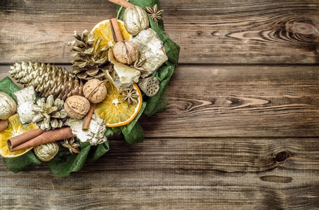 Christmas wreath with dried fruits on wooden tableの写真素材