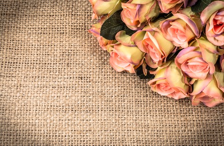 Pink roses on rustic background. Flowers frame, floral greeting card.の写真素材