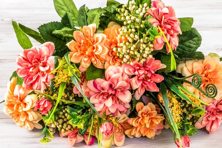 Mixed flowers bouquet on wooden background, mothers day, greeting cardの写真素材