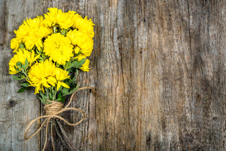 Yellow flowers frame, floral greeting card, bouquet on wood, copy spaceの写真素材