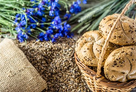 Fresh baked bread rolls on rustic wooden table, bakery products backgroundの写真素材