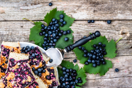 Sweet pastry with blueberry fruits on yeast pie, summer baking concept from aboveの写真素材