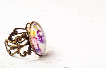 Handmade ring with antique gold isolated on wood backgroundの写真素材