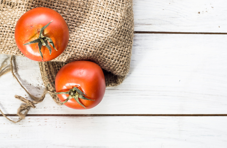 Fresh tomatoes, organic vegetables from local market on wooden tableの写真素材