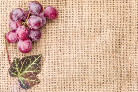 Red grapes, bunch on rustic background, healthy eating conceptの写真素材