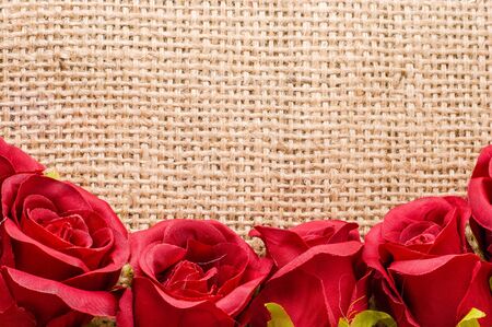 Red roses on wooden background, flowers frame for valentine card or wedding invitation, templateの写真素材