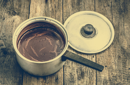 Hot chocolate drink melted in a pot, cooking homemade sweet dessertの写真素材