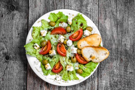 Plate of salad, greek food, mediterranean diet with vegetables and feta, top viewの写真素材