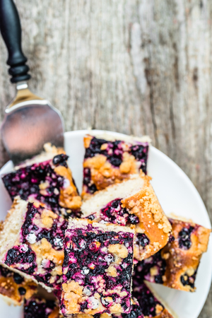 Sweet cake with blueberry fruits on yeast pastry, summer baking concept, top viewの写真素材