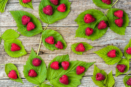 Fresh raspberry fruits flat lay overhead, wooden table