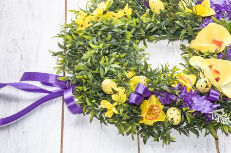 Background for easter, card with eggs and flowers on white table, home decorの写真素材
