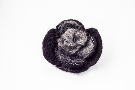 Felt brooch. Handmade stylish felt jewelry made with dark felt isolated on a white background.の写真素材