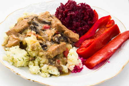 Stew with vegetables closeup on white plate, cooking conceptの写真素材