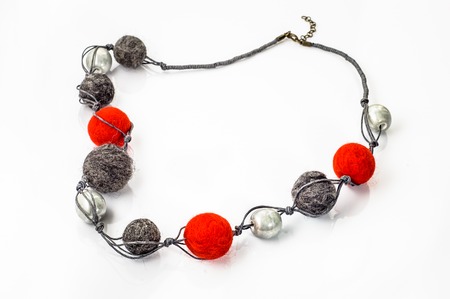 Felt necklace. Handmade stylish felt jewelry made with colorful felt beads isolated on a white backgroundの写真素材