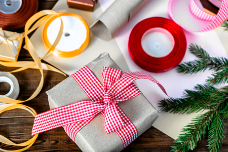 Christmas gift box in rustic package, present wrapped in paper and ribbonの写真素材
