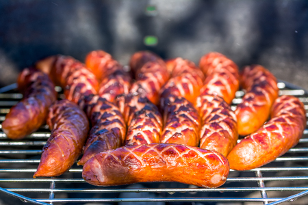 Grilled sausage on barbecue grill, picnic outdoorsの写真素材