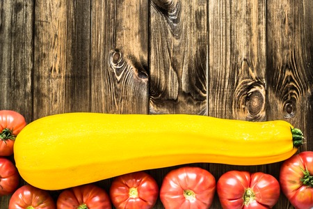 Farm fresh organic vegetables, tomatoes and zucchini, letcho ingredients on wooden backgroundの写真素材