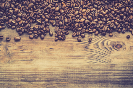 Roasted coffee beans background, black coffee's grain on wooden tableの写真素材