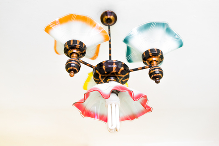 Retro chandelier with energy efficient bulb hanging under ceilingの写真素材