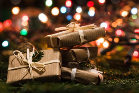 Christmas eve with gift boxes on lights backgroundの写真素材